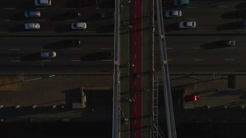 Top view of a massive foot bridge with people walking over a highway, 4k Stock Footage 163894722