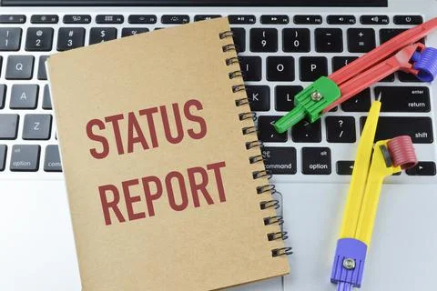 Top view of math compass and notebook written with STATUS REPORT Stock Photos