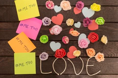 Top view of Me too message written in colorful stickers on a love knoted back Stock Photos