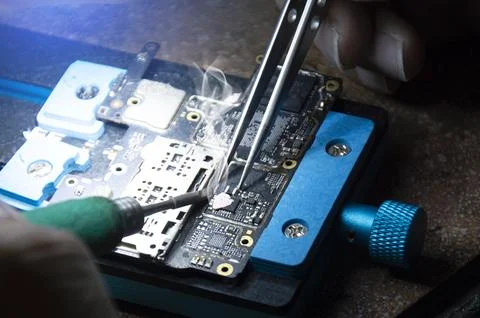 Top view, mechanic doing repairs Smartphone motherboard, smartphone repair,.. Stock Photos