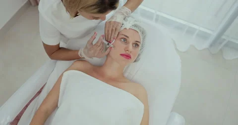 Top view medium close-up shot of platelet rich plasma face injections procedure Stock Footage 160294290