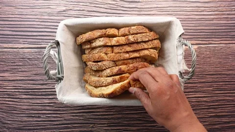 Top view of men hand pick whole grain bread from a basket 스톡 동영상 269103755