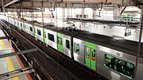 Top View of Metro Train on JR Yamanote Line leaving the station and depart Video stock 189389070