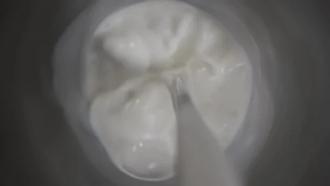 Top view milk being poured in glass dark table, close up pouring milk on black Stock Footage 107706294