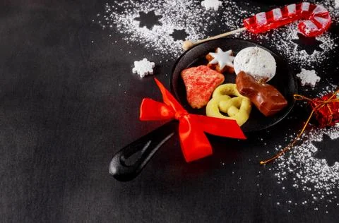 Top view of mini iron skillets with sweets. Christmas cookie, chocolate and c Stock Photos