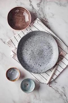 Top view of minimalist table setting with ceramic plates and bowls on marbl.. Stock Photos