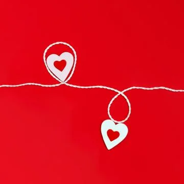 Top view of a minimalistic composition for Valentine's day on a red backgroun Stock Photos