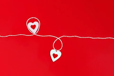 Top view of a minimalistic composition for Valentine's day on a red backgroun Stock Photos