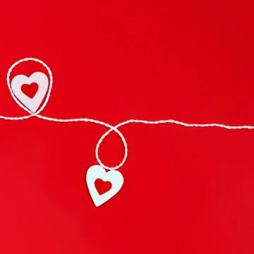 Top view of a minimalistic composition for Valentine's day on a red backgroun Stock Photos