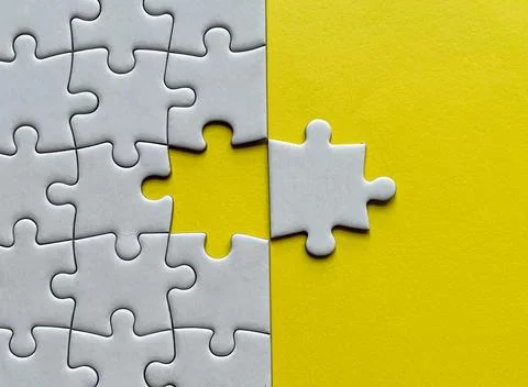 Top view of missing jigsaw puzzle with customizable space for text on yellow Stock Photos