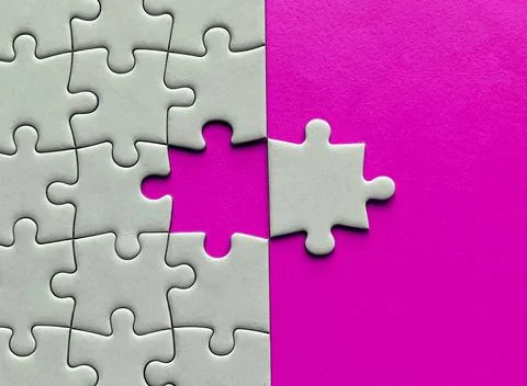 Top view of missing jigsaw puzzle with customizable space for text on pink color Stock Photos