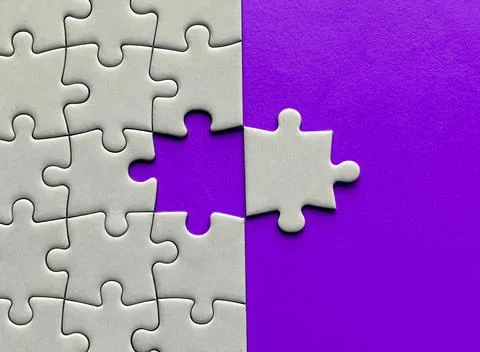 Top view of missing jigsaw puzzle with customizable space for text on maroon Stock Photos