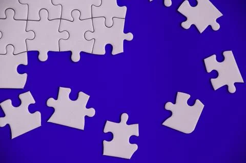 Top view of missing jigsaw puzzle on blue cover background. Copy space. 写真素材