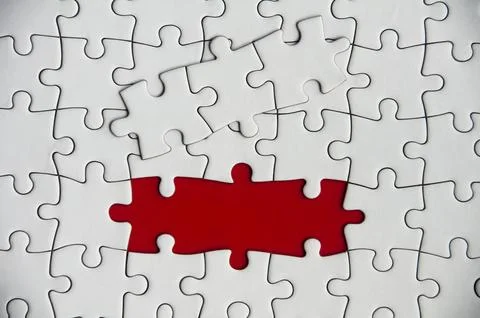 Top view of missing jigsaw puzzle on red cover background. Copy space 写真素材
