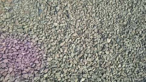 Top view of mixed grey and purple crushed stones for construction and lands.. Fotos de archivo