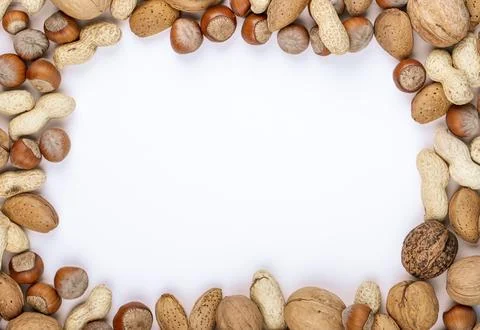 Top view of mixed nuts in shell hazelnuts peanuts walnuts and almond on whi.. Stock Photos