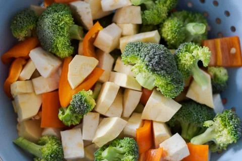 Top view of mixed root vegetables for making broth lying in strainer Stock Photos