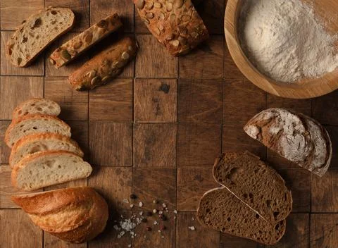 Top view of mixed rustic fresh backed Bread with flour and spices on the wo.. Stock Photos