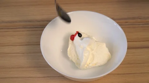 Top view of mixing the cream for decorating and dye in the bowl. Cooking Stock Footage 86767649