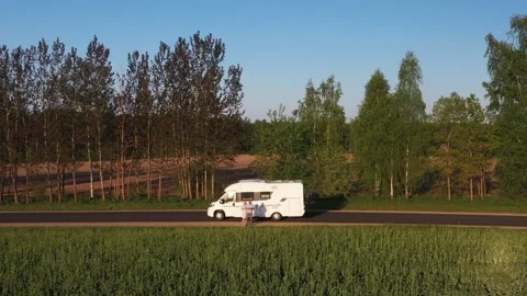 Top view of a mobile home and a married couple traveling on the road Stock Footage 256636563