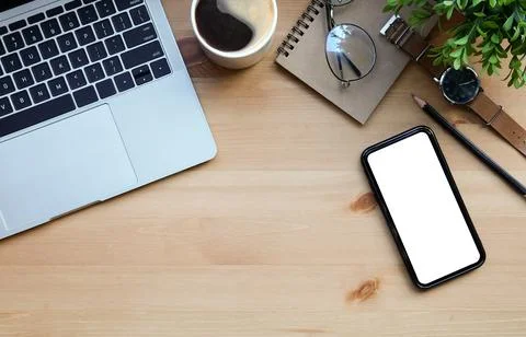 Top view mobile phone, computer laptop, notebook, coffee cup and plant on woo Stock Photos