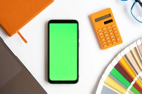 Top view of Mobile Phone Device Green Screen on Designer Worktop. Close Up... Stock Photos