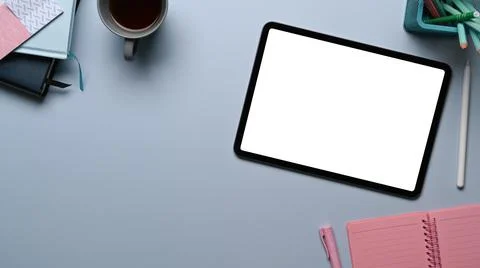 Top view of mock up digital tablet with blank screen, notebook, coffee cup an Stock Photos