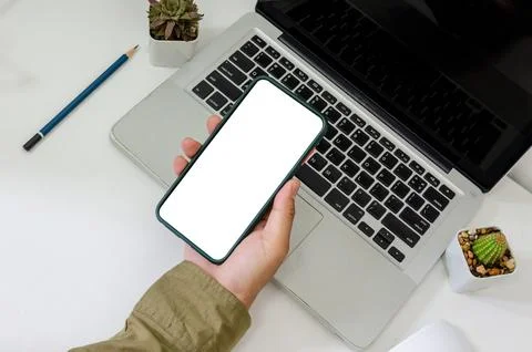 Top view mock up hand holding smart phone white blank screen and pencil mou.. Stock Photos