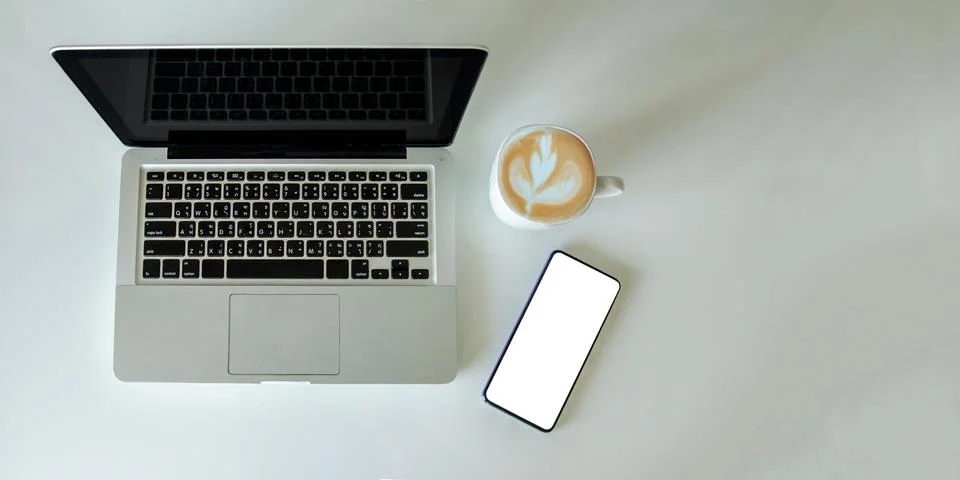 Top view mock up smartphone with mouse computer laptop and coffee cup.Copy .. Stock Photos