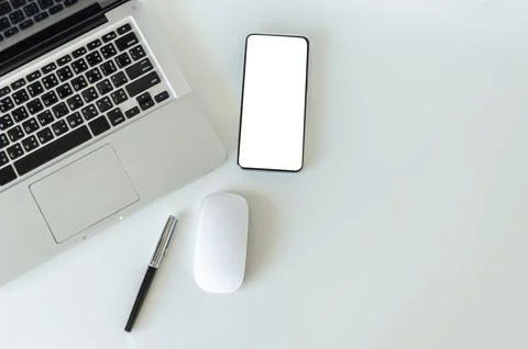 Top view mock up smartphone with mouse computer latop and pen.Copy space fl.. Stock Photos
