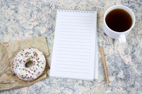 Top view mock upnotebook with   blank  white paper sheet ,coffee cup and donu Stock Photos