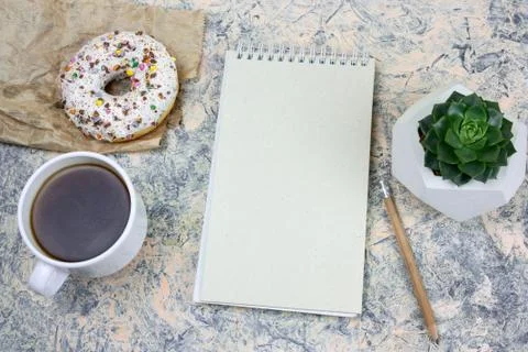 Top view mock upnotebook with   blank  white paper sheet ,coffee cup and donu Stock Photos