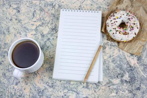 Top view mock upnotebook with   blank  white paper sheet ,coffee cup and donu Stock Photos
