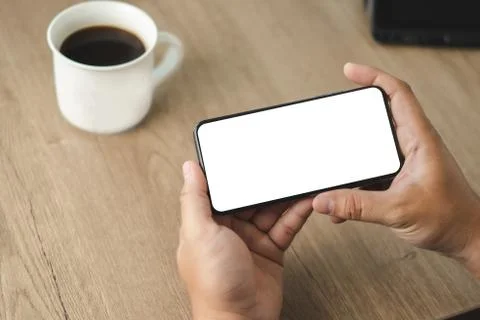 Top view Mockup image hand using a smartphone man Holding Cell Phone With Bla Stock Photos