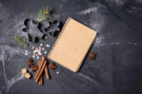 Top view of mockup notepad for recipe and christmas baking ingredients on bla Stock Photos