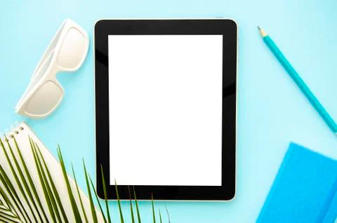 Top view mockup summer work desk. Tablet pc with notepad, sunglasses and palm Stock Photos