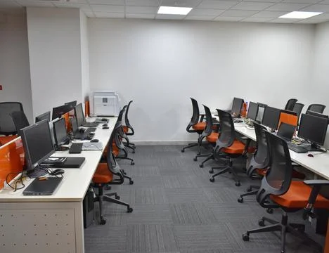 Top view of modern open space office with white walls, concrete floor and row Stock Photos