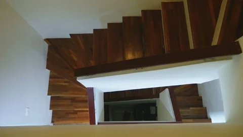 Top view of a modern staircase with brown wooden steps and white walls. three Video stock 99866372
