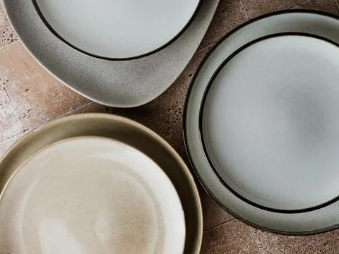 Top view of modern various ceramic plates on a kitchen table, cooking concept Stock Photos