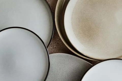 Top view of modern various ceramic plates on a kitchen table, cooking concept Stock-Fotos