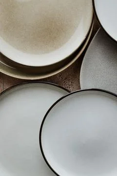 Top view of modern various ceramic plates on a kitchen table, cooking concept Stock Photos