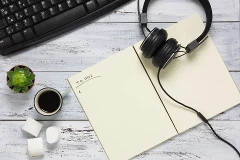 Top view of a modern workplace with open empty notebook. Stock Photos