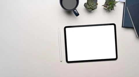 Top view of modern workspace with mock up digital tablet with blank screen an Stock Photos