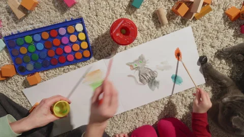 Top view of moms and daughters hands painting together, family pet portrait, cat Stock Footage 233899228