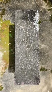 Top view of a moss covered stone bench Stock Photos