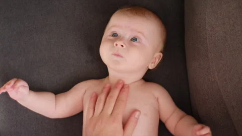 Top view of mother hands massaging cute little baby. Skin care concept Stock Footage 253814313