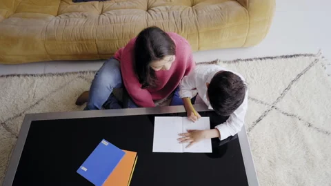 Top view mother helping her son to do homework for school Spbi. Child writing Stock Footage 150664689