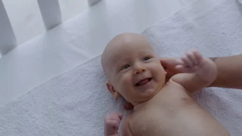 Top view, mother puts wet baby on bed after bath Stock Footage 306003836