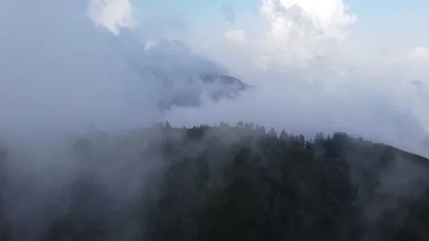 Top view of mountain covered with fog and clouds drone shot. Vidéo 237971925