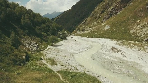 Top view mountain river. Hiking group walking along mountain river Stock-Footage 81068975